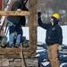 Construction worker Dan Haydon and David Haig of DA Haig Construction, work on a support post as they carefully take apart a historic barn at Zingerman's Cornman Farms in Dexter on Monday, March 4, 2013. Melanie Maxwell I AnnArbor.com